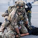 Using helicopters and chemical agents, immigration agents become increasingly aggressive in Chicago